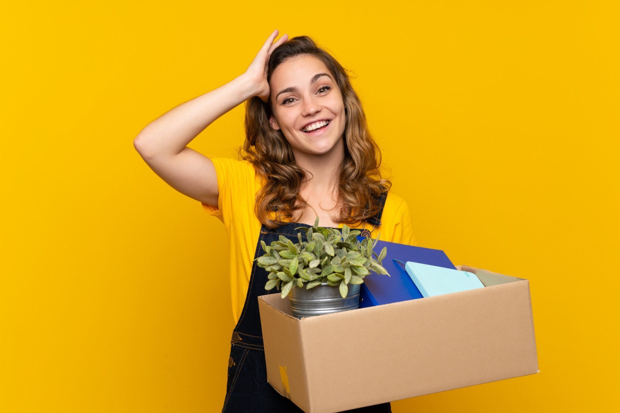Shop Umzug 1 young blonde girl making a move while picking up a box full of things with surprise and shocked facial expression 2